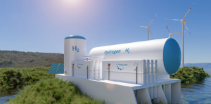 A hydrogen tank facility rests next to wind turbines on a grassy plain overlooking the sea.