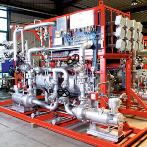 A red and silver heat transfer unit with wheels sits in an industrial facility