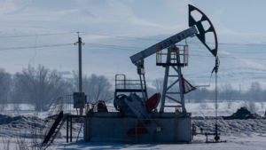 An oil drilling station in a cold, snowy landscape